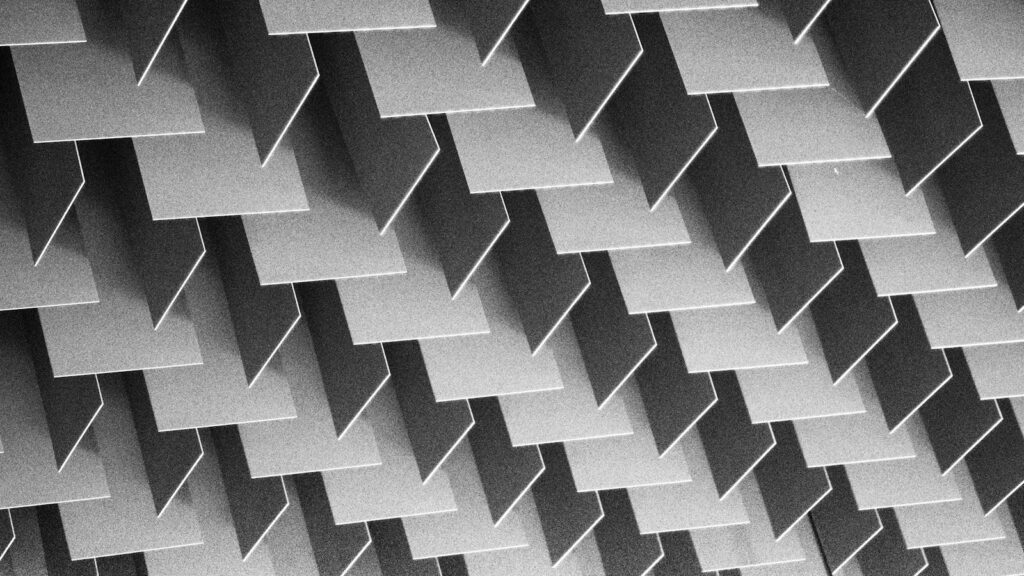 A repeating pattern of identical grey rectangular panels arranged in a geometric grid.